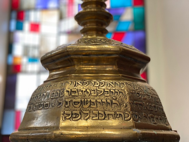 A close up of the top of an old brass bell