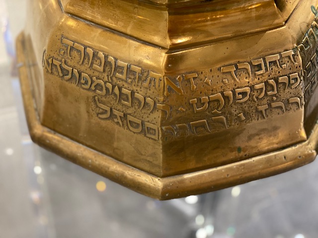 A close up of the lettering on a gold object